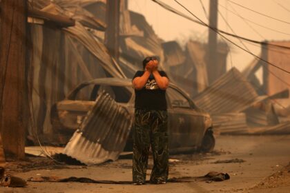 A resident in front of charred ruins in Concepcion, one of the cities hit by wildfires in