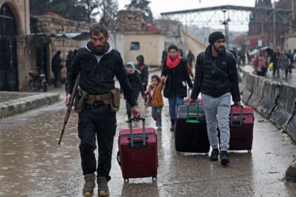 Residents of Aleppo's Sheikh Maqsoud area evacuate after warnings from the Syrian arm