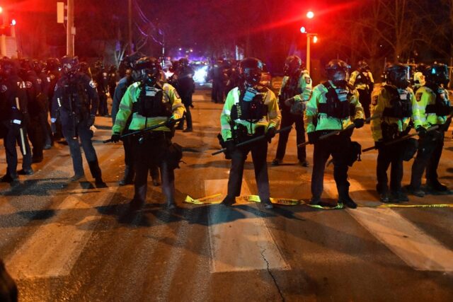 State troopers form a line in a Minneapolis street amid protests against federal immigrati