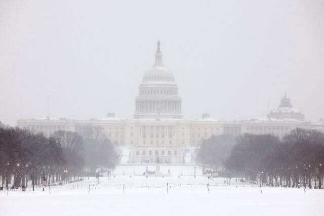 Washington awoke to a blanket of snow expected to cause travel headaches for days