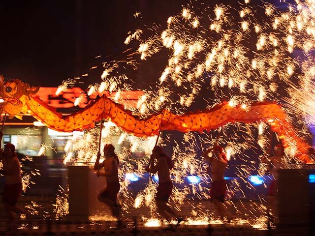 Title: China Lunar New Year Image ID: 26045566599091 Article: Fire performers carry a drag