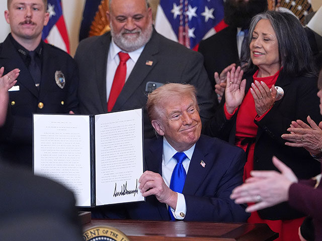 Title: Trump Image ID: 26054594751917 Article: President Donald Trump holds a signed procl