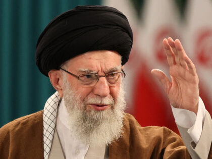 Iran's Supreme Leader Ayatollah Ali Khamenei waves to his supporters during a press c