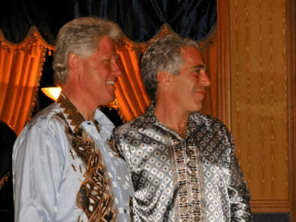 Former President Bill Clinton stands with Jeffrey Epstein in this image released by the De