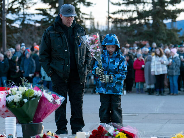 Canada school shooting A young boy brings flowers to a memorial in honor of the victims of one of Canada's d
