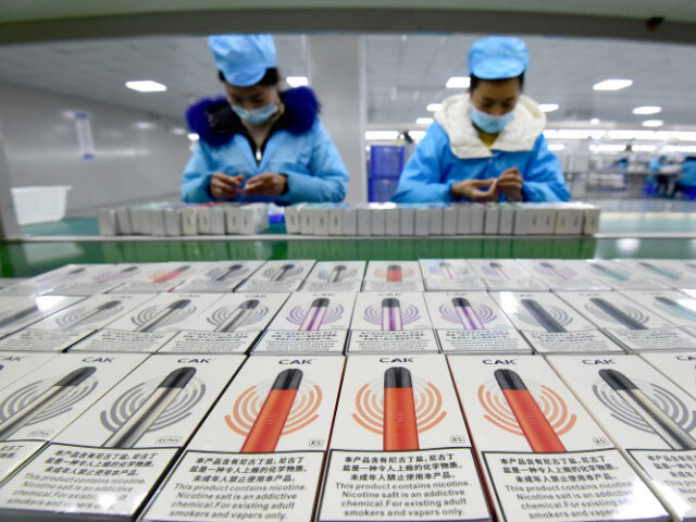 Chinese E-Cigarettes Workers work on the production line of electronic cigarettes at an electronic technology c