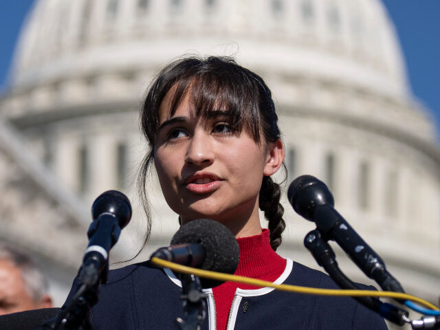 Chloe Cole speaks as Rep. Marjorie Taylor Greene (R-GA) looks on during a news conference