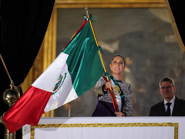 President of Mexico Claudia Sheinbaum waves the Mexican flag during the annual shout of In