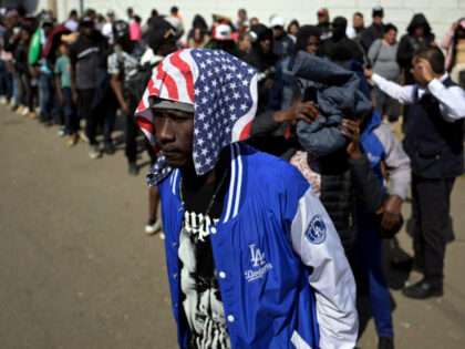 A migrant waits outside the facilities of the Commission for Refugee Assistance (COMAR) to