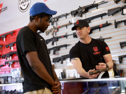 DELRAY BEACH, FLORIDA - JANUARY 31: Brandon Wexler helps Kimani O'Reilly shop for a handgu