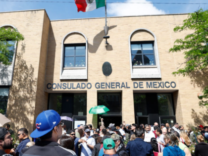 Mexican nationals wait to cast their vote in the Mexican presidential election at the Mexi