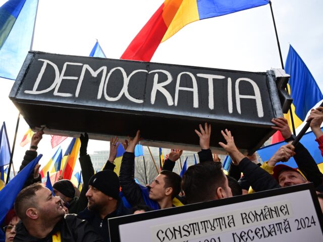 TOPSHOT - People carry a mock-up coffin reading "Democracy" during a protest in front of R