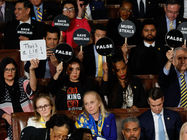 Washington, DC - March 4: Democrat lawmakers hold up signs to protest as President Donald