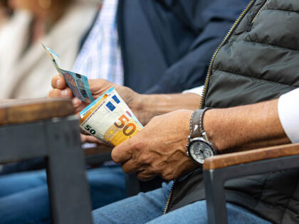 A customer pays with euro banknotes at a restaurant terrace in Bremen, Germany, on Saturda