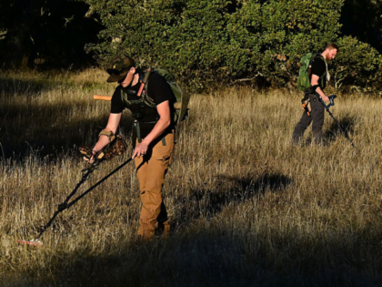 YouTuber Matt James (L) and Cody Blanchard of Heritage Gold Rush use metal detectors to de