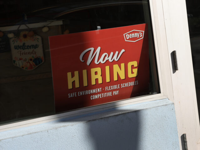 MIAMI, FLORIDA - NOVEMBER 19: A 'Now Hiring' sign sits in the window of a Denny&