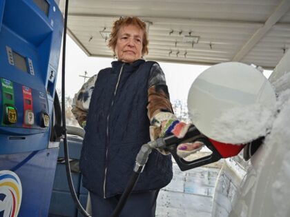 Customer Jann Gregg of Schenectady pumps gas at the GasWay Xpress Mart at 1120 Erie Blvd.