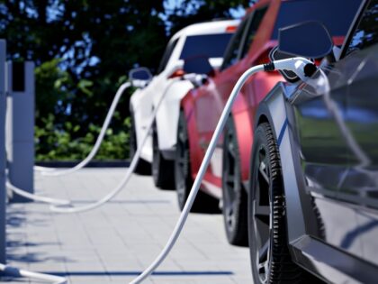 Generic electric cars charging on a city street This image doesn`t contain any visible tra