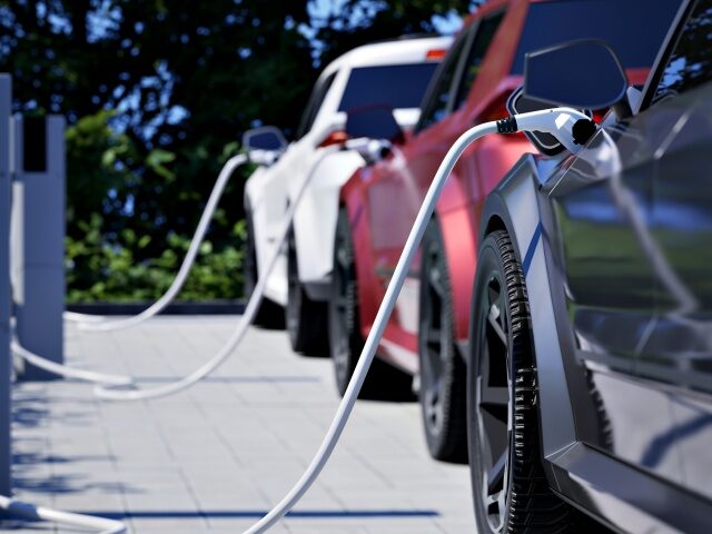 Electric Cars Charging Generic electric cars charging on a city street This image doesn`t contain any visible tra