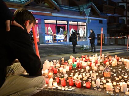 CRANS-MONTANA, SWITZERLAND - JANUARY 01: Mourners light candles at the scene after a fire