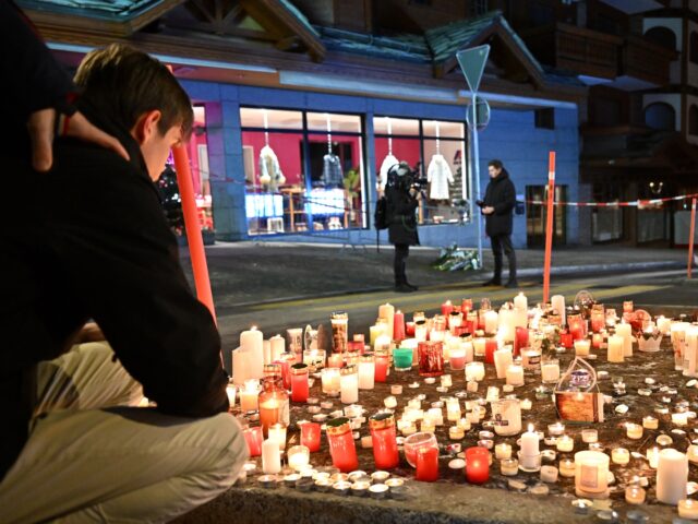 CRANS-MONTANA, SWITZERLAND - JANUARY 01: Mourners light candles at the scene after a fire