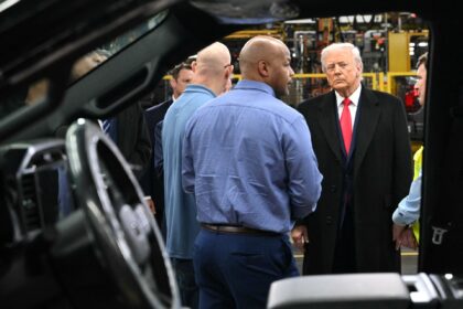 US President Donald Trump speaks with Ford CEO Jim Farley (R) and plant manager Corey Will