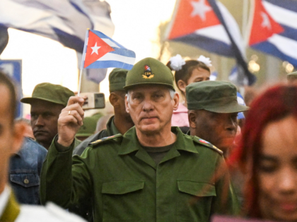 Cuba's President Miguel Diaz-Canel (C) takes part in the "Anti-Imperialist" protest in fro