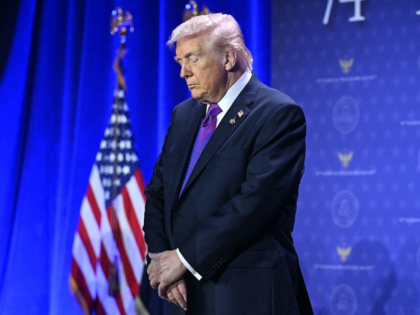 US President Donald Trump bows his head in prayer during the National Prayer Breakfast at