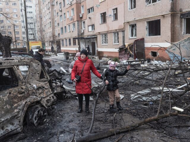 KRAMATORSK, UKRAINE - FEBRUARY 8: A mother and her daughter leave their home, damaged afte