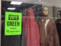 A poster promoting Britain's Green party is pictured in the window of a clothes retailer i