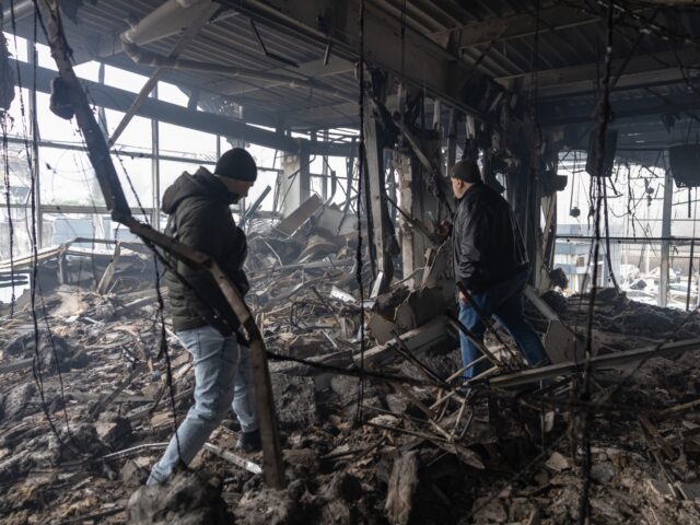 ODESA, UKRAINE - FEBRUARY 13: Men walk among the ruins of a building after a Russian UAV s