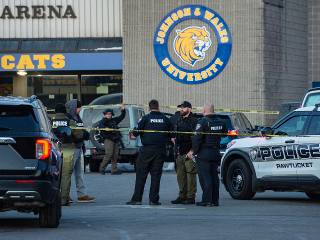 Police stand outside the perimeter they created around the Dennis M. Lynch Arena where a s