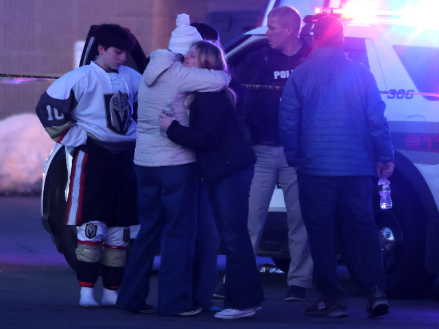 Pawtucket, RI - February 16: People embrace at the scene of a mass shooting at Dennis M. L
