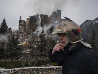 Firefighters work at the site of residential buildings damaged by Russian drone and missil