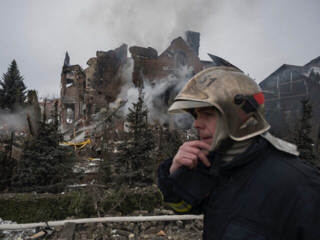Firefighters work at the site of residential buildings damaged by Russian drone and missil