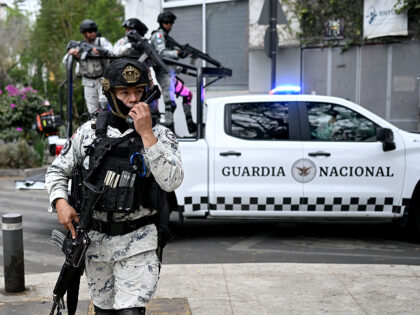 GettyImages-2262548384 (1) Mexican National Guard special forces escort an ambulance from the forensic service upon i