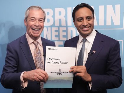 Party leader Nigel Farage with Reform UK's home affairs spokesman Zia Yusuf holding t