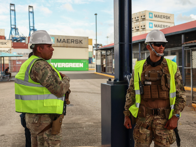 Panamanian police officers patrol the area at the Port of Balboa, managed by CK Hutchison