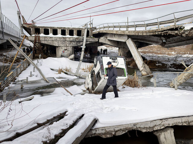 IRPIN, UKRAINE - FEBRUARY 24: People gather under the Irpin bridge in commemoration of the