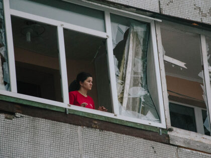 Consequences Of The Attack On Kharkiv A resident of a building damaged by a Shahed attack looks out of a shattered window in Kha