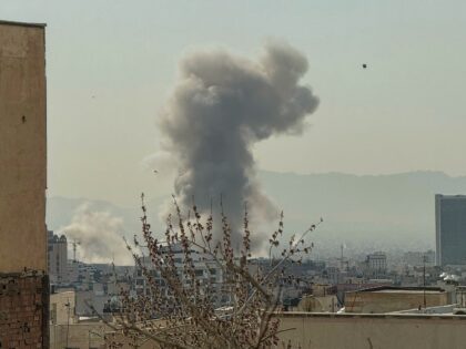 A plume of smoke rises over Tehran after a reported explosion on February 28, 2026, after