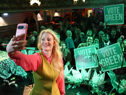 MANCHESTER, ENGLAND - FEBRUARY 26: Green Party candidate and winner Hannah Spencer celebra