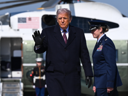 JOINT BASE ANDREWS, MARYLAND - FEBRUARY 27: U.S. President Donald Trump waves while boardi