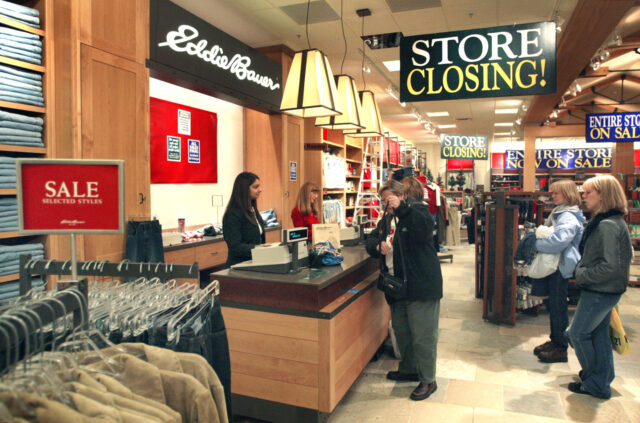 BLOOMINGDALE, IL - JANUARY 9: Shoppers pay for their purchases at a closing Eddie Bauer s