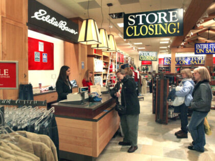 BLOOMINGDALE, IL - JANUARY 9: Shoppers pay for their purchases at a closing Eddie Bauer s