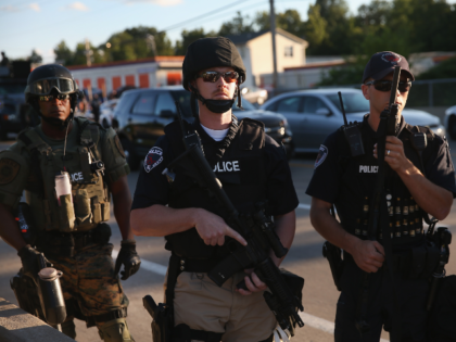 FERGUSON, MO - AUGUST 12: Police take up position to control demonstrators who were protes