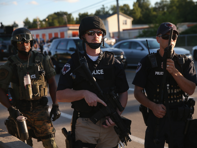 FERGUSON, MO - AUGUST 12: Police take up position to control demonstrators who were protes