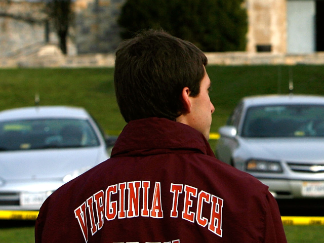 GettyImages-73913996 BLACKSBURG, VA - APRIL 18: A student stands across the street from Norris Hall after repor