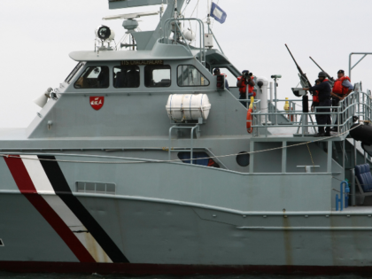 Officers on a Coastguard vessel patrol the coast of Port of Spain a day before the opening