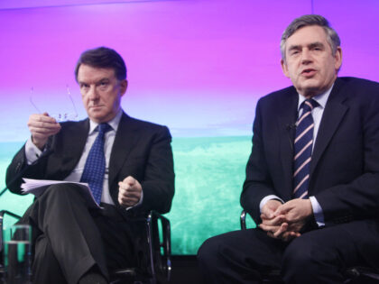 Gordon Brown, U.K. prime minister, right, speaks during a press conference as Peter Mandel